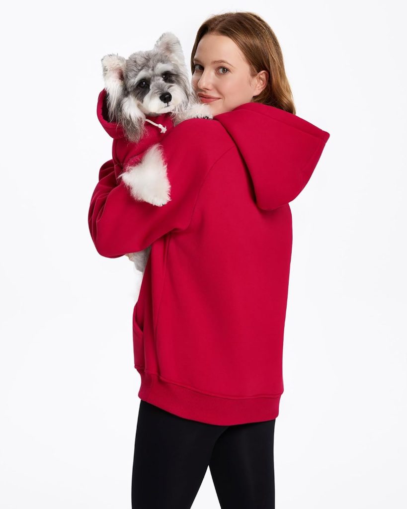 woman and dog wearing red hoodies